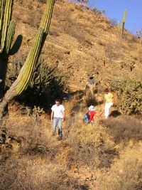 Students in desert near possible landslide deposits